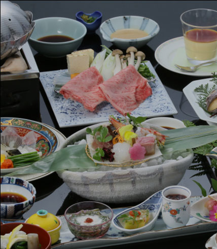 あわびやふぐ刺し、すき焼きなど様々な料理が並んだ会席料理