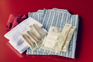 Yukata (Japanese bathrobe) and amenity set including toothbrush and towel provided by the accommodation facility.
