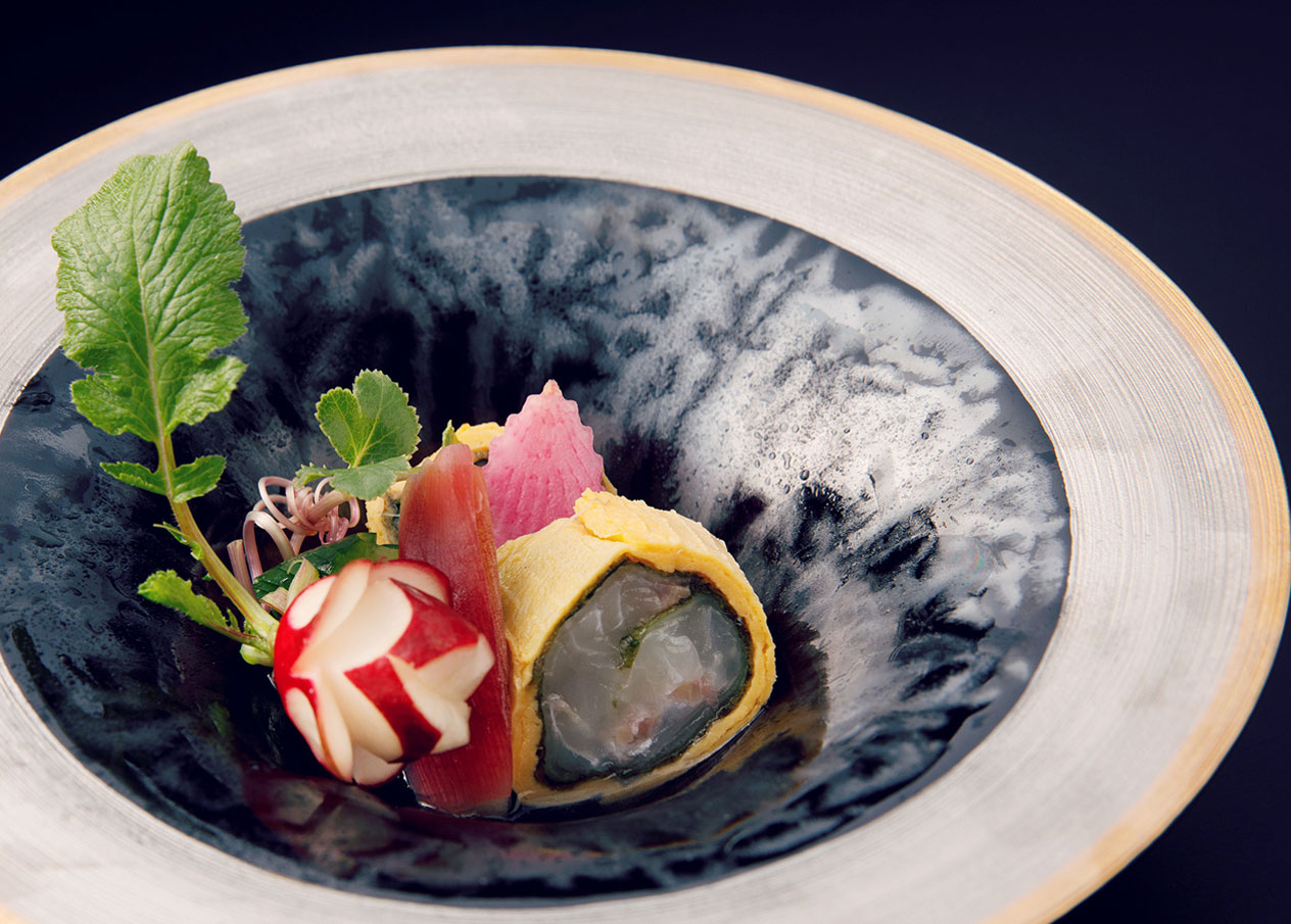 黒い器に美しく盛り付けられた前菜料理のアップ。